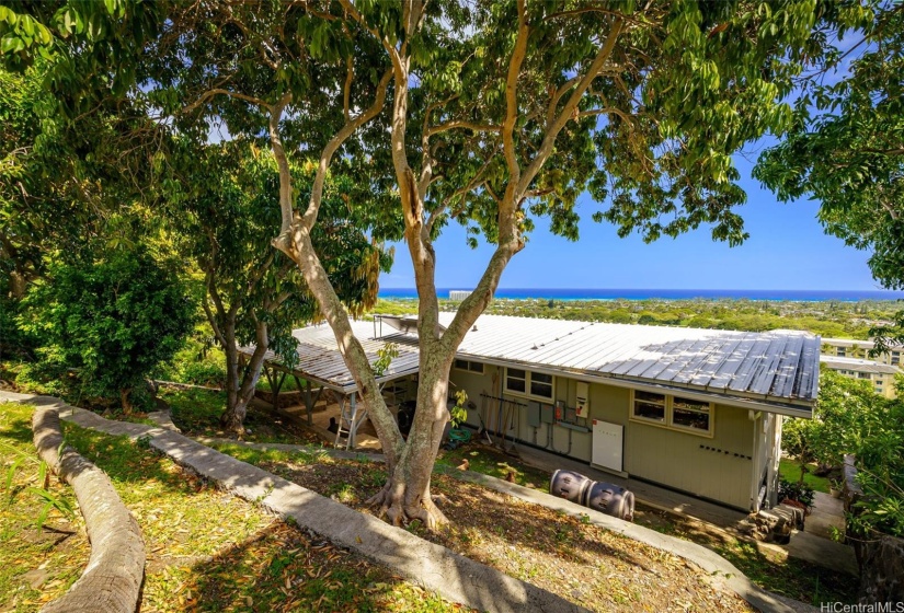 The back yard is terraced with mature landscaping.  Convenient steps along the right side of the home to access the yard without going through the house.