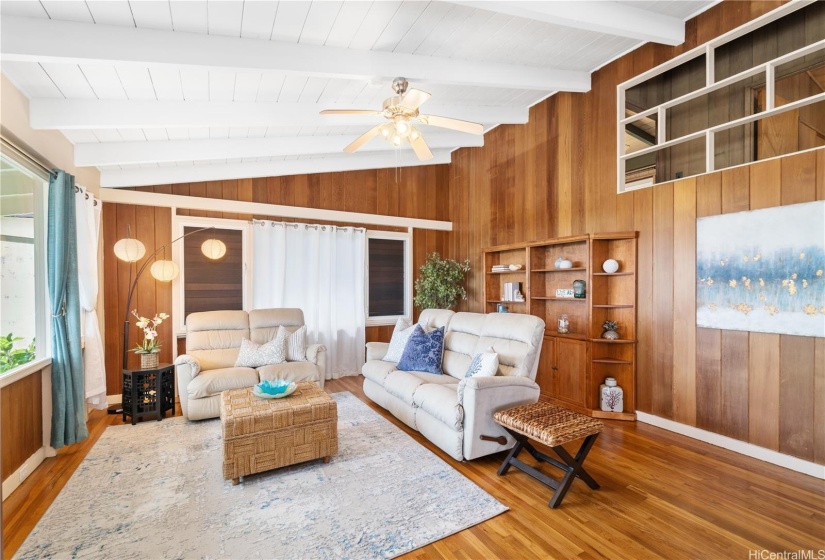 Back inside, enjoy a spacious living room featuring beautiful solid wood floors and breathtaking vistas!