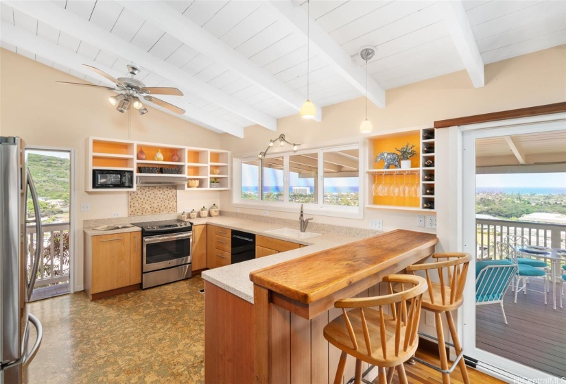 Updated kitchen with wood cabinets, quartz and natural wood counters, and amazing views for the chef.