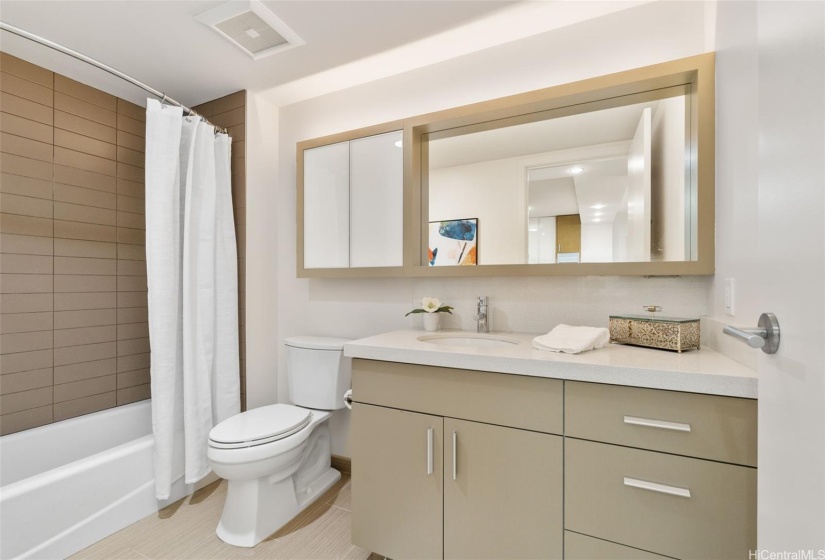 Second bathroom also includes durable and cool ceramic tile as well as single basin vanity with quartz counter and lots of storage.  This bathroom features a combination soaking tub shower.