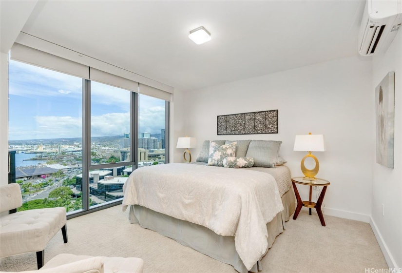 Bright and spacious primary suite features floor to ceiling windows to enjoy the view.  Blackout shades keep things dark and cool for those lazy sleep-in Saturdays.  The split AC also helps to keep it cool.