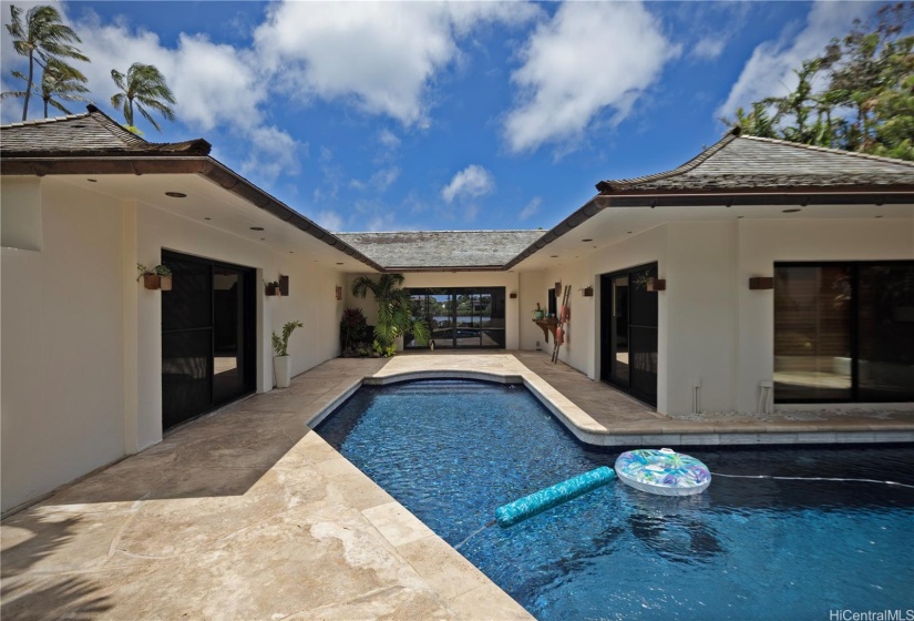 Exit to courtyard with an en suite bedroom on either side