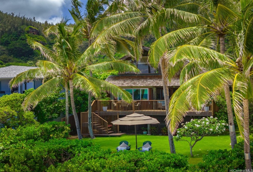 The expansive lawn area. Lush green sanctuary that complements this homes beachfront setting. Great for various outdoor activities or making the lawn a perfect spot for peaceful relaxation