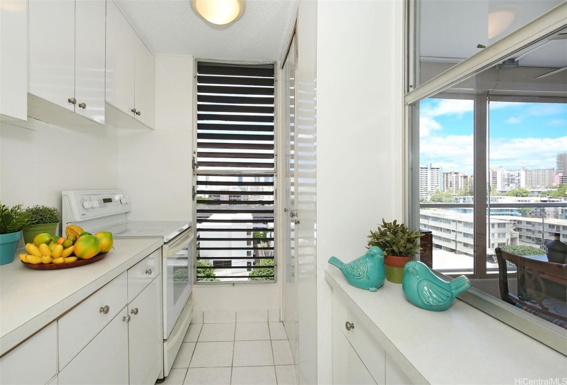 Spacious kitchen with Honolulu city view and pass-thru window to the lanai