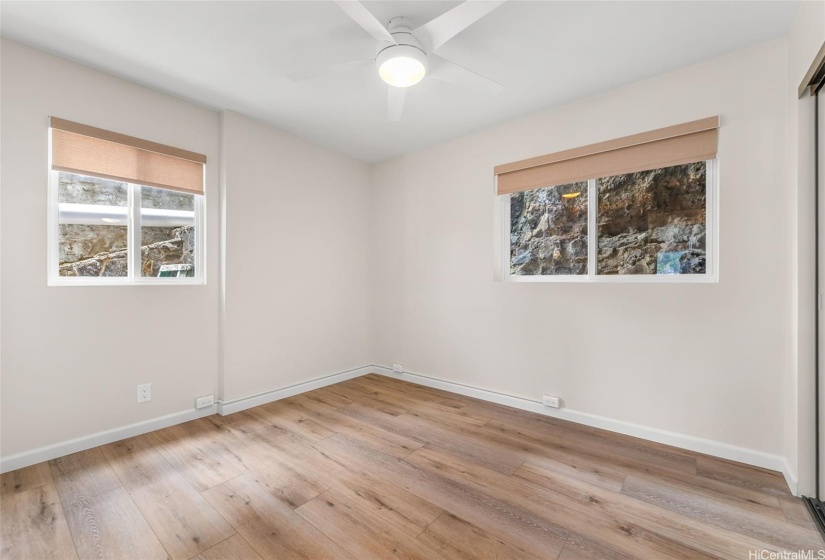 One of two 1st level bedrooms, each of similar size. Manual Levolor windows shades.