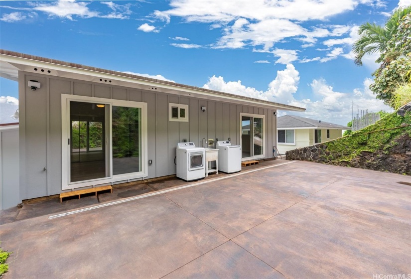 Upper level laundry situated on patio between 2 of 4 bedrooms.