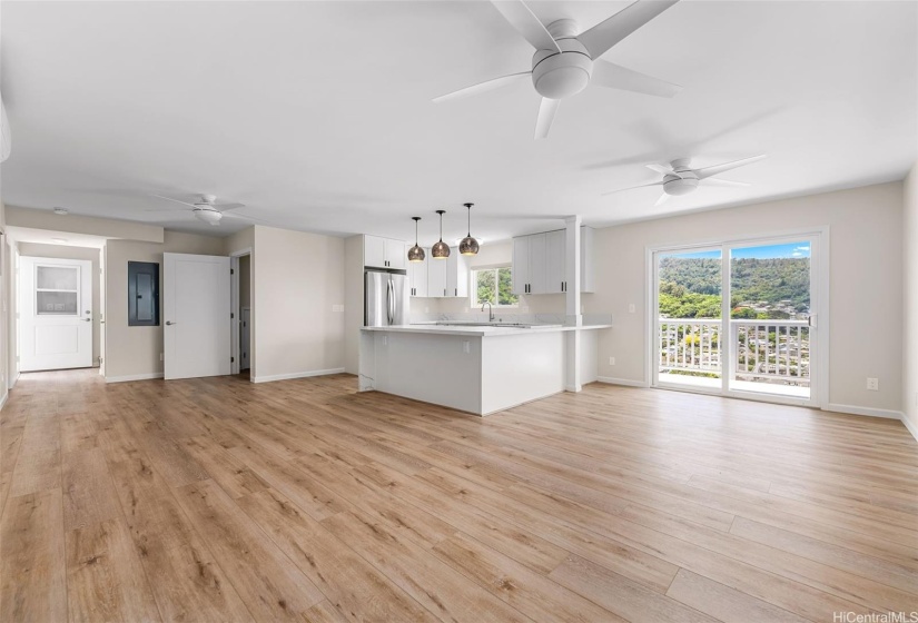 Upper level main floor depicting beautiful kitchen with designer features for form & function. Lanai at right. Entry door from interior stairs at center left; behind it are interior stairs to 4th level bedrooms. Opposite door opens to exterior stairs to patio.