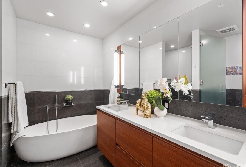 Primary Luxury Bathroom complete with quartz double sink vanity, free standing bathtub, walk in shower and separate water closet. Stone flooring adds to the richness here.