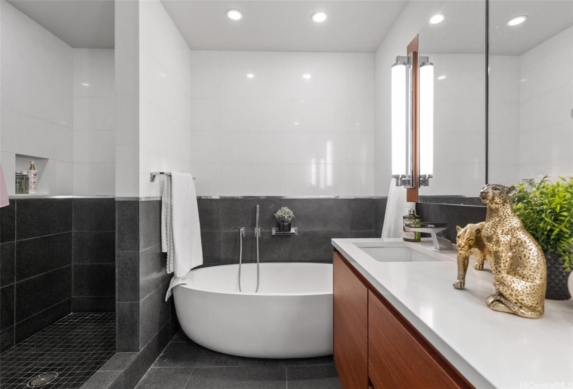 Primary bathroom showing walk in shower stall to the left. Rich and quality finishes surround you.