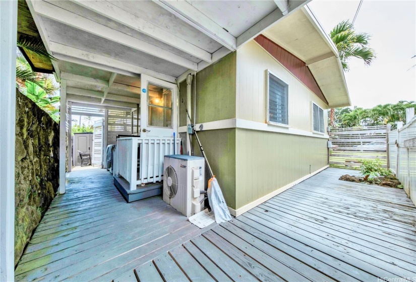 Back door leads to covered fenced in deck. Washer & Dryer behind the door. Storage shed out to the left.