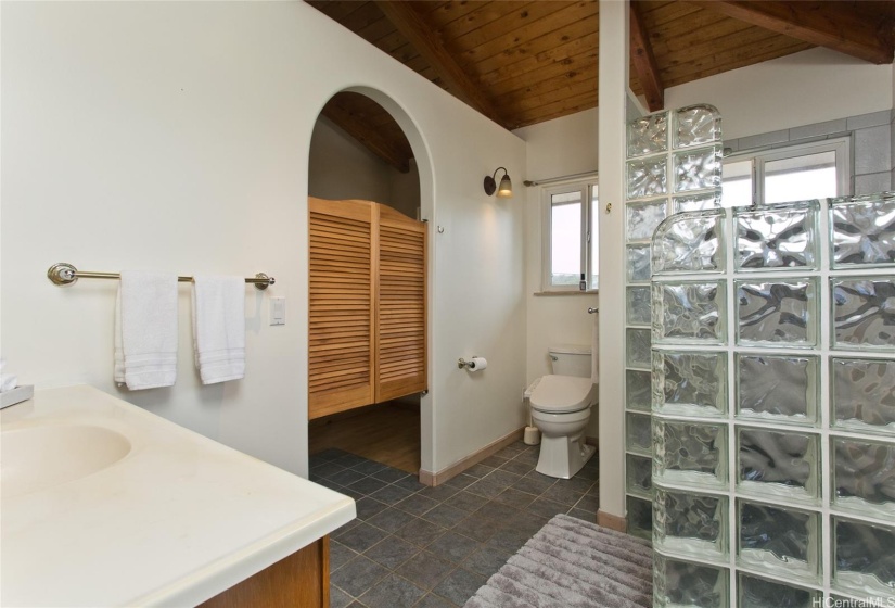 Primary Private Bathroom with Walk-In Glass Tile Shower and panoramic mountain view with windows opening up to the trade-winds!