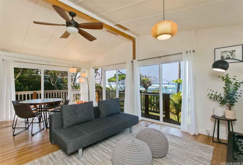 Lower Level Living Room with convenient exterior deck leading down to lawn and white sand beach.