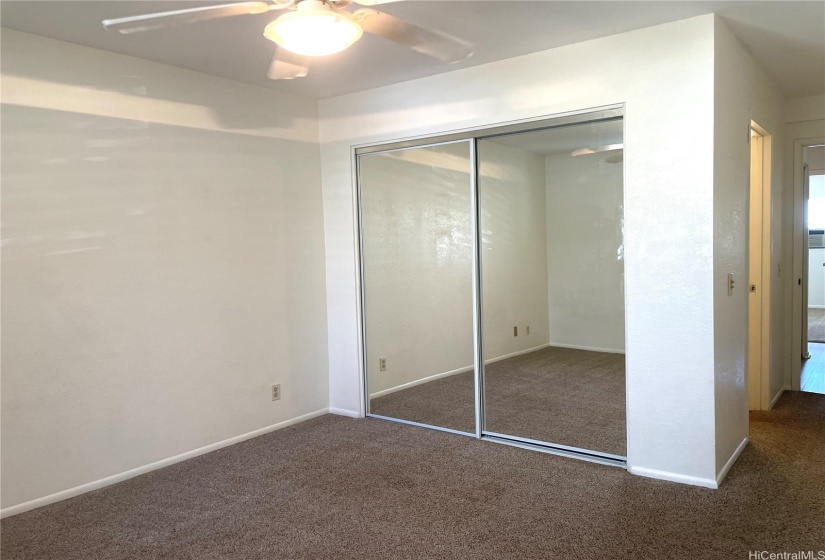 Primary Bedroom w/mirrored closet doors.