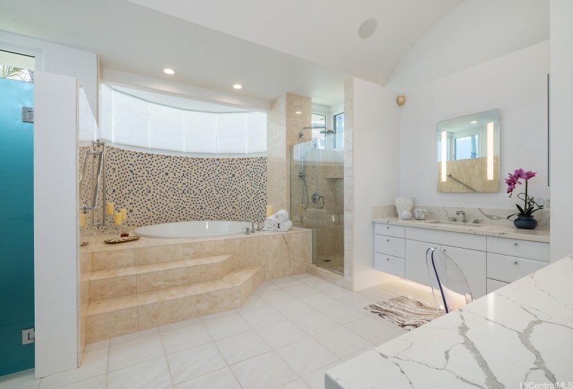 Luxurious ensuite bathroom with a jetted bathtub and separate shower enclosure