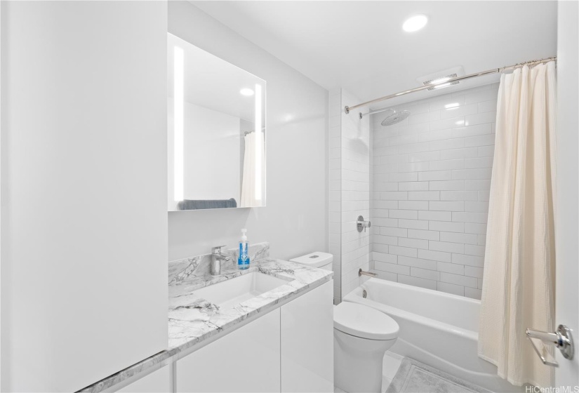 Full bathroom includes a beautiful lighted mirror.