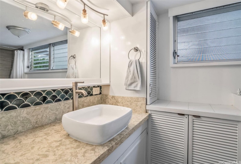 Primary bathroom with renovated showers, sink, counter tops, and toilet