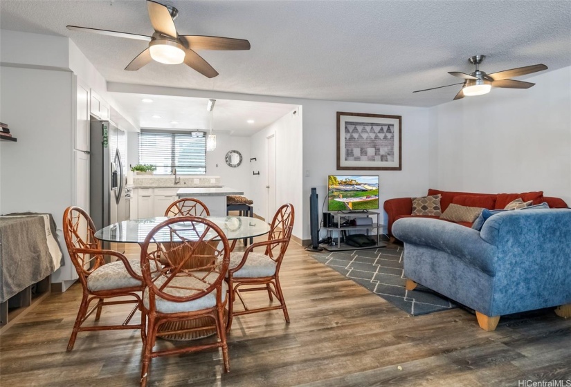 Open concept kitchen and living area with vinyl plank flooring