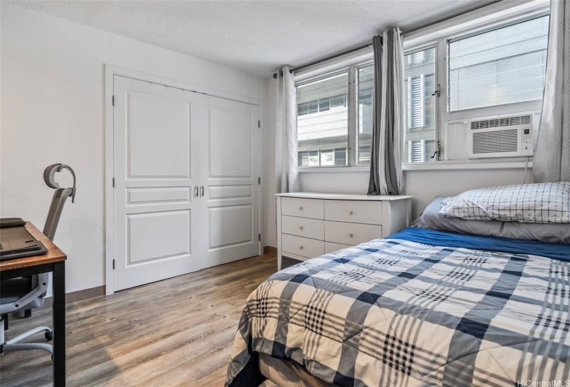 Second bedroom with closet and window AC unit