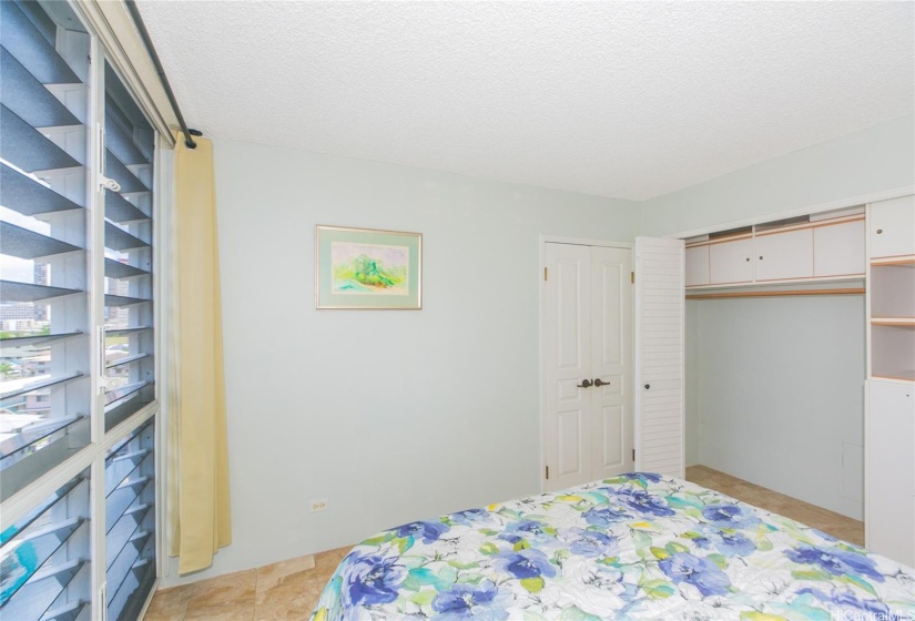 Fitted closet, elegant double door entry to bedroom.