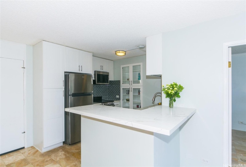 Cabinets extend all the way to the ceiling.