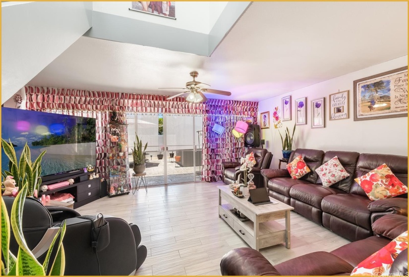 Spacious Downstairs Living Room with View of Back Patio