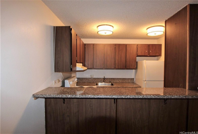 Kitchen has a convenient counter for casual dining.