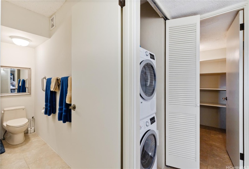 Second downstairs bathroom with a new shower, the washer and dryer, the large,  created storage closet at the end of the hall.