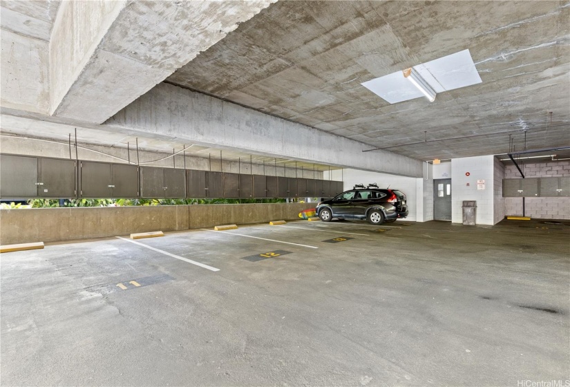 Parking stalls 12 and 13 are covered with storage lockers.  Through the door is the elevator for building 2 to take you up to your penthouse.  One more parking stall, an open #6, in the same garage comes with this unit.