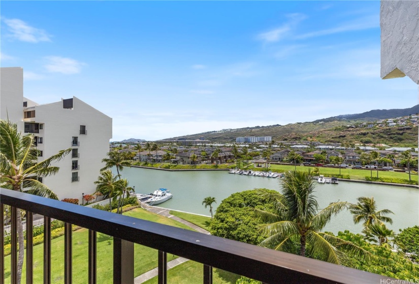 View from lanai overlooking the park bordering the Marina.  Boat docks for residents are to the left in front of the other building 1 in the complex.