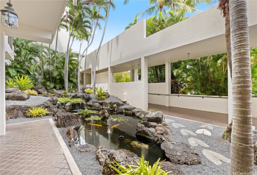 Walking to the elevator for building 2 from the center circle of the building, you will pass the koi pond and water feature.