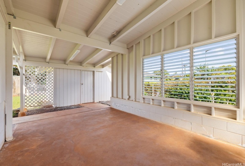 Covered patio area on side of home leads to the workshop.