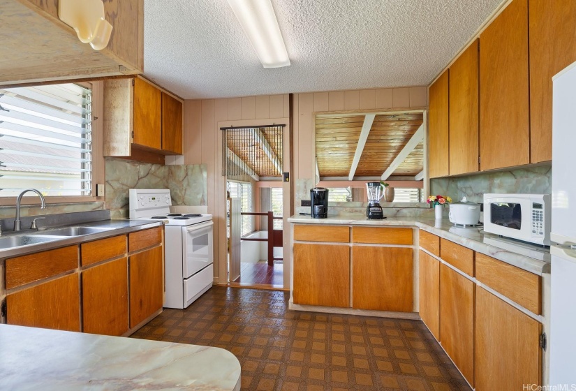 Clean kitchen space with stainless steel sink and countertop.