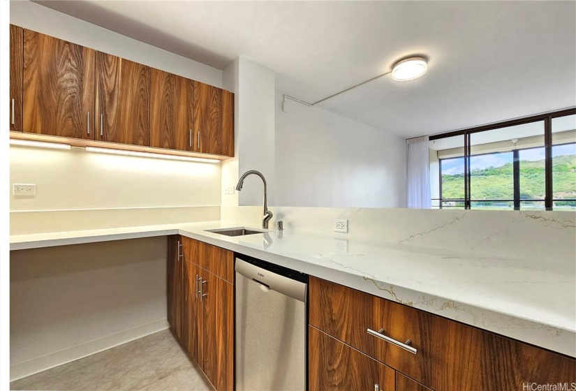 Kitchen with new countertops, cabinets, appliances and flooring.