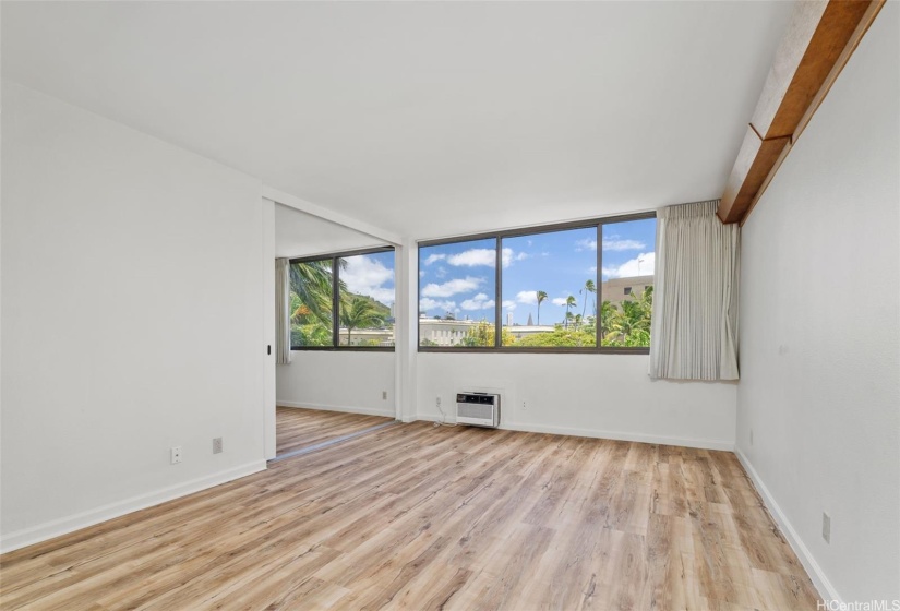 Spacious living rom with large windows letting in plenty of natural light