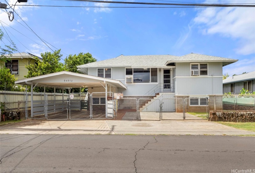 Flat lot with ample parking and great street frontage. The carport features an entrance #1 into the unfinished basement