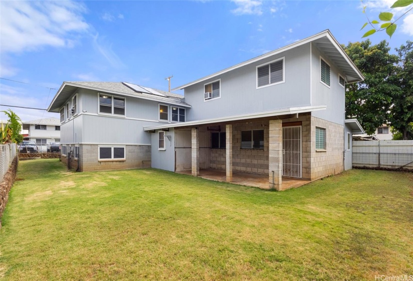 Spacious grassy yard that is all fenced in. Covered patio #1 and bonus covered storage. There is also a separate entrance #4 into the downstairs addition