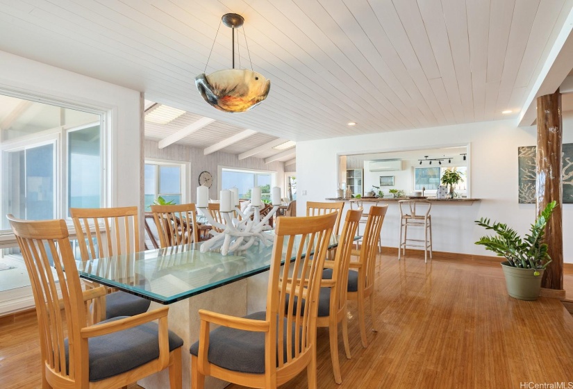 The formal dining area and breakfast bar sit above the sunken living room with a large pass through bar to the kitchen.