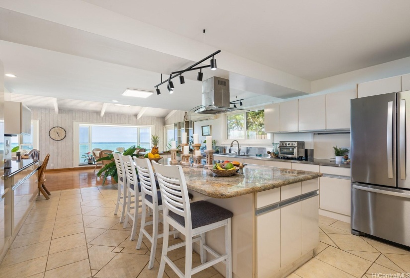 This spacious kitchen offers an oversized center island, a lowered desk/management area, a walk-in pantry and plenty of seating at 3 different bar areas.