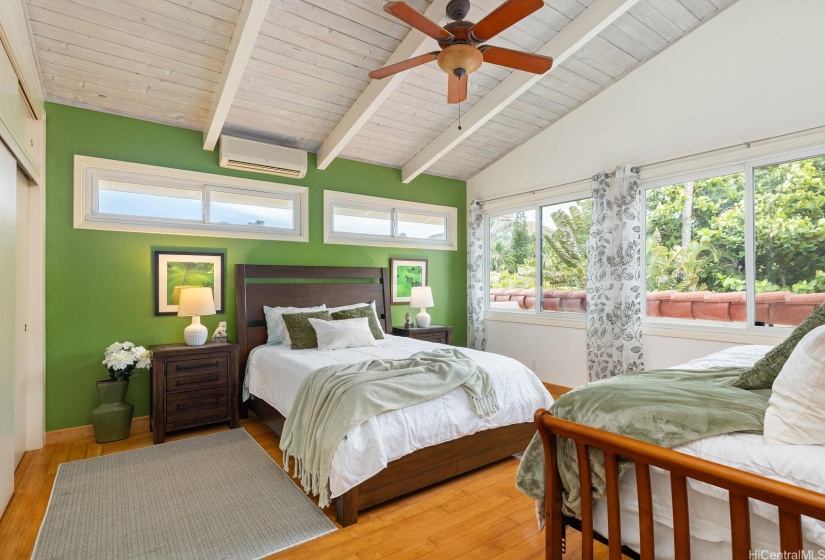 This upstairs mauka garden bedroom is large enough to fit two beds and makes a great guest room.  Every other upstairs bedroom enjoys beautiful ocean views and all feature vaulted ceilings.