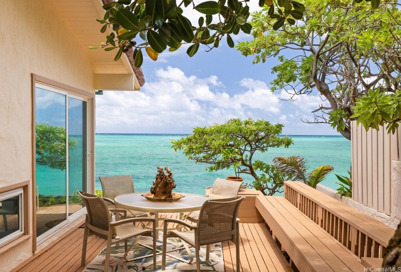 Another angle of the charming outdoor area off the kitchen side. The lanai wraps the exterior and connects to the front along both sides of the property.