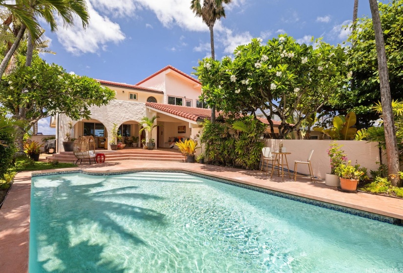 The luscious landscaping and sparkling pool offers ample room for entertaining or relaxing.