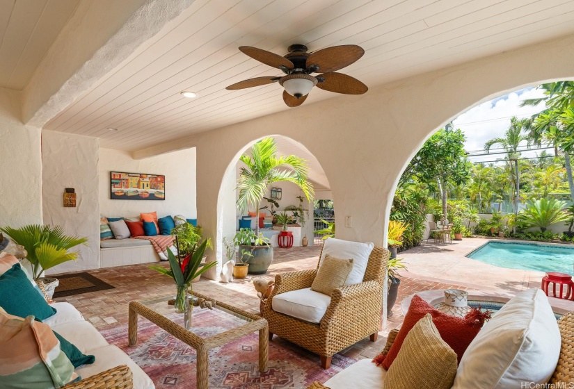 Front lanai near the entrance is shaded and has a lovely view of the pool and hillside. The outdoor living area is spacious and gets a cool breeze.