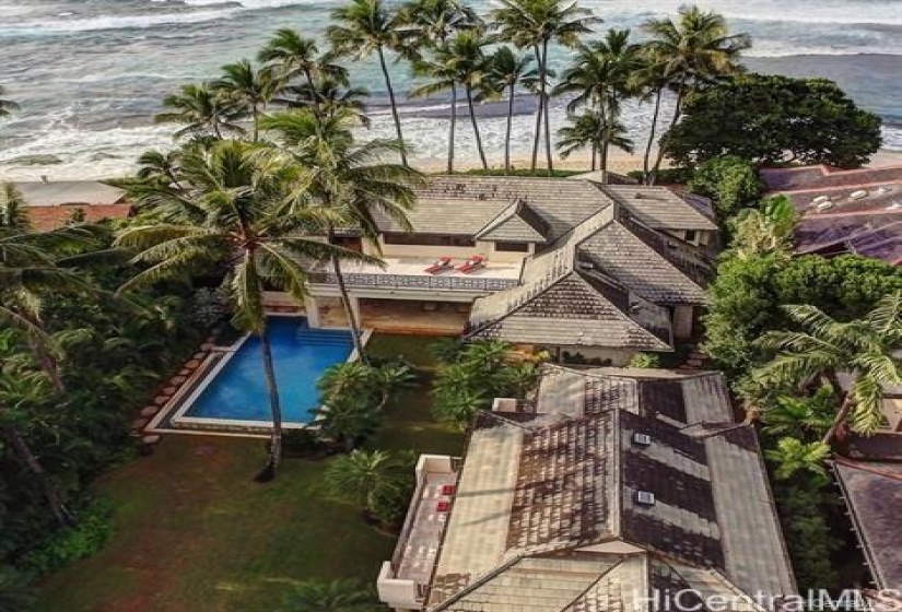 Drone view of two dwellings. One area of pool is a 