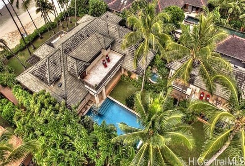 Drone shot of main beachfront dwelling and guest house. Heated pool and Jacuzzi. Main dwelling has two bedrooms (master on suite upstairs with it’s own private deck;guest bedroom is downstairs with ocean view). Downstairs has spacious living room;separate dining room;media room with AC; chef’s kitchen;laundry room and outside dining table for 8. All bedrooms have AC.