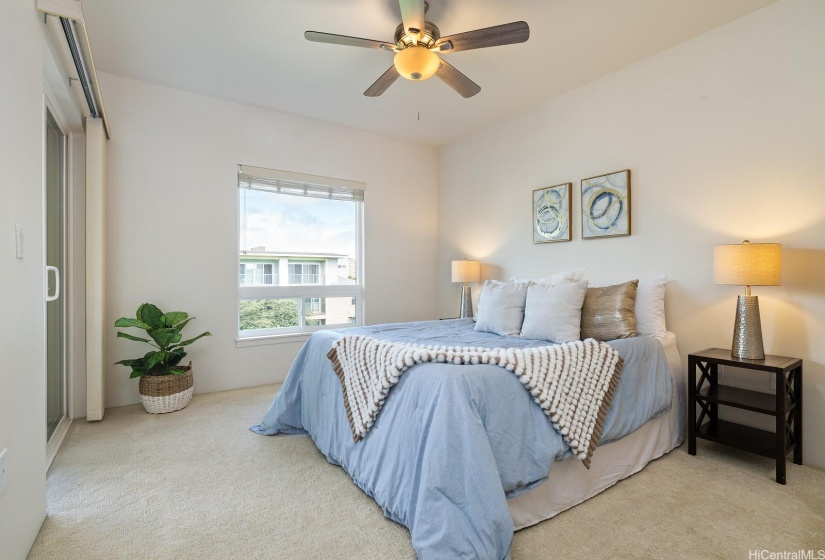 The primary bedroom is spacious and has access to the lanai.