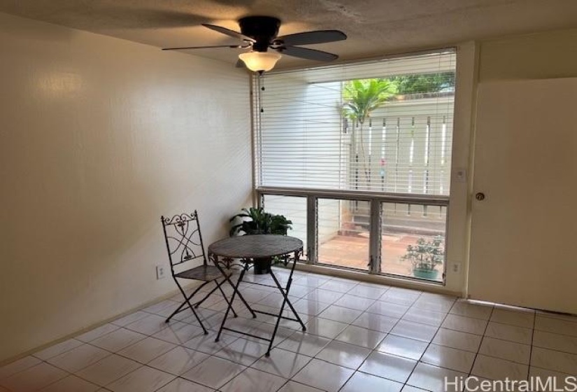 Spacious dining area has wide window glass and opens to front porch.