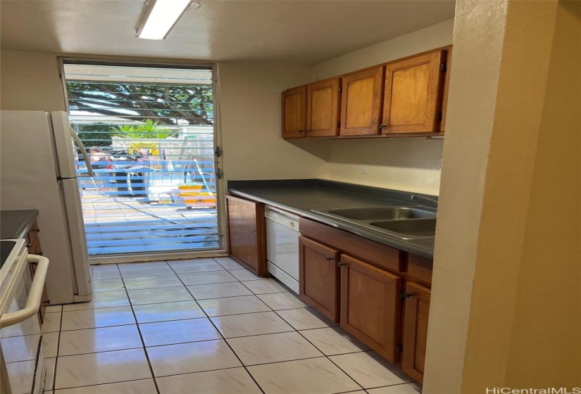 Floor to ceiling window jealousies makes the kitchen bright.