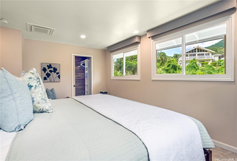 The primary bedroom has large windows for great airflow, natural lighting and greenery views. Custom blinds throughout.