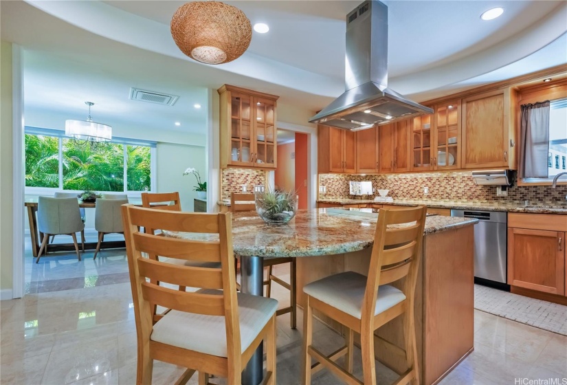 This custom kitchen was exceptionally designed and features, glass cabinetry doors with interior lighting, eat-at island, stainless steel appliances, water filtration system, built-in office desk area and recessed lighting.