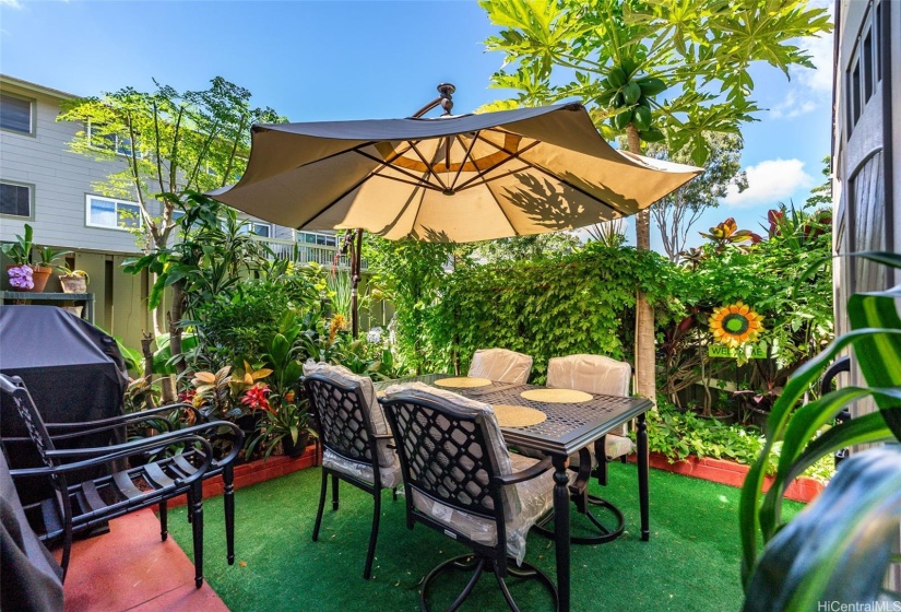 Large courtyard with fruit bearing trees and veggies